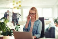 Businesswoman sitting in her office using a cellphone and laptop - PhotoDune Item for Sale