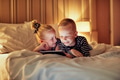 Laughing little brother and sister watching videos before bedtime - PhotoDune Item for Sale