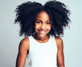 Cute Young African girl smiling confidently against a gray background - PhotoDune Item for Sale