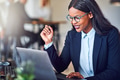 Smiling young African American businesswoman working online in her office - PhotoDune Item for Sale