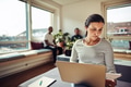 Businesswoman using a laptop and reading documents in an office - PhotoDune Item for Sale