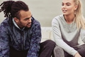 Smiling young couple talking while taking a break from running - PhotoDune Item for Sale