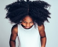 Shy little African preschooler looking down against a gray background - PhotoDune Item for Sale