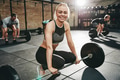 Fit young woman smiling in a weightlifting class - PhotoDune Item for Sale