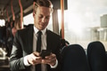 Smiling young businessman sending texts while riding on a bus - PhotoDune Item for Sale