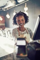 Smiling restaurant waitress holding an electronic card payment machine - PhotoDune Item for Sale
