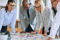 Diverse businesspeople trying to solve a jigsaw puzzle together - PhotoDune Item for Sale