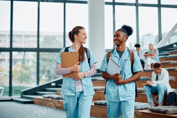Happy black medical student communicating with female friend after the lecture at the university.
