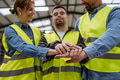 Portrait of young man with Down syndrome and his colleagues working in warehouse, holding hands as - PhotoDune Item for Sale