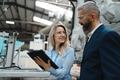 Female engineer and male supervisor standing in modern industrial factory, talking about production - PhotoDune Item for Sale
