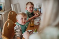 Family eating breakfast together in home kitchen. Healthy breakfast or snack before preschool - PhotoDune Item for Sale