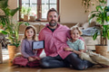 Father and kids holding smart thermostat, adjusting, lowering heating temperature at home. Concept - PhotoDune Item for Sale
