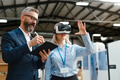 Engineers talking project using VR, in modern industrial factory. Virtual reality in manufacturing - PhotoDune Item for Sale