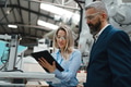 Female engineer and male supervisor standing in modern industrial factory, talking about production - PhotoDune Item for Sale