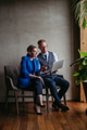 Two colleagues sitting near window and working on notebook in modern office full of plants. - PhotoDune Item for Sale