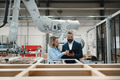 Female engineer and male project manager standing in modern industrial factory, talking about - PhotoDune Item for Sale