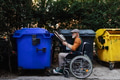 Senior man in wheelchair throwing paper waste, cardboard into recycling container in front his - PhotoDune Item for Sale