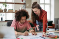 Young colleagues working together in startup company. - PhotoDune Item for Sale