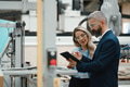 Female engineer and male production manager standing in modern industrial factory, talking about - PhotoDune Item for Sale