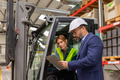Female forklift driver talking with manager in warehouse, order picking. Warehouse worker preparing - PhotoDune Item for Sale