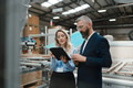 Female engineer and male project manager standing in modern industrial factory, talking about - PhotoDune Item for Sale