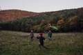 Girl flying kite on meadow, running, having fun with parents. Autumn windy weather for kite flying. - PhotoDune Item for Sale