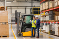 Female forklift driver, warehouse worker talking with manager, standing by forklift. Warehouse - PhotoDune Item for Sale