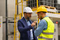 Supervisor, manager scolding employee in modern industry factory. Worker making mistake. Production - PhotoDune Item for Sale