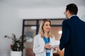 Pharmaceutical sales representative talking with female doctor in medical building, convicing her to - PhotoDune Item for Sale