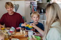 Family eating breakfast together in home kitchen, toasting with juice. Healthy breakfast or snack - PhotoDune Item for Sale
