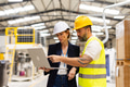 Female manager talking with foreman, checking production plan on notebook. Woman quality controller - PhotoDune Item for Sale