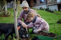 Girl and father planting tree in garden in the spring, using compost. Concept of sustainable - PhotoDune Item for Sale