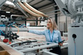 Female engineer in modern industrial factory, checking robotic arm, controling process and - PhotoDune Item for Sale