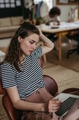 Young woman working on laptop in creative studio. - PhotoDune Item for Sale