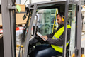 Warehouse worker driving forklift. Forklift driver reading order, order picking. Warehouse worker - PhotoDune Item for Sale