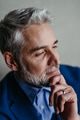 Handsome man with gray hair and beard smiling, looking aside studio portrait on gray copy space. - PhotoDune Item for Sale