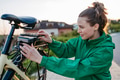 Young woman with electro bicycle, concept of commuting and ecologic traveling. - PhotoDune Item for Sale