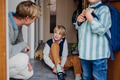 Children getting ready for school, putting on shoes, getting dressed. Father taking them to school - PhotoDune Item for Sale