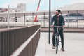 Contemporary bearded young stylish businessman going to work by bike - PhotoDune Item for Sale