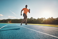 Young African athlete sprinting down a running track - PhotoDune Item for Sale