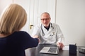 Senior doctor handshaking with patient in clinic - PhotoDune Item for Sale