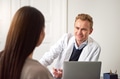 Cheerful male beautician consulting woman at laptop in salon - PhotoDune Item for Sale