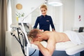 Smiling technician performing electrolysis on a male client - PhotoDune Item for Sale