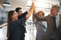 Business team high fiving each other in an office - PhotoDune Item for Sale