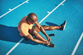 Young athlete tying up his shoes on a running track - PhotoDune Item for Sale