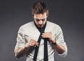 Young businessman putting on his tie for the business day - PhotoDune Item for Sale