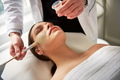 Woman lying with eyes closed while beautician putting mask - PhotoDune Item for Sale