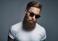 Stylish young hipster with a long beard wearing sunglasses - PhotoDune Item for Sale