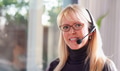 Attractive Businesswoman Wearing Telephone Headset In An Office Setting. - PhotoDune Item for Sale