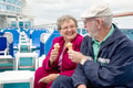 Happy Senior Adult Couple Enjoying Ice Cream On The Deck of a Luxury Passenger Cruise Ship. - PhotoDune Item for Sale